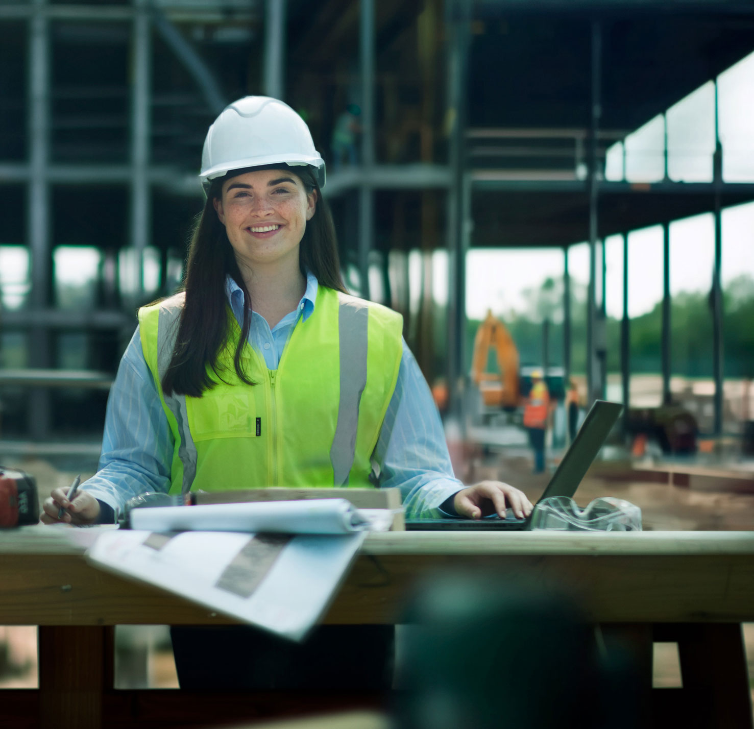 Photo of a St Cuthbert’s girl as an engineering or construction professional, standing on a large building site