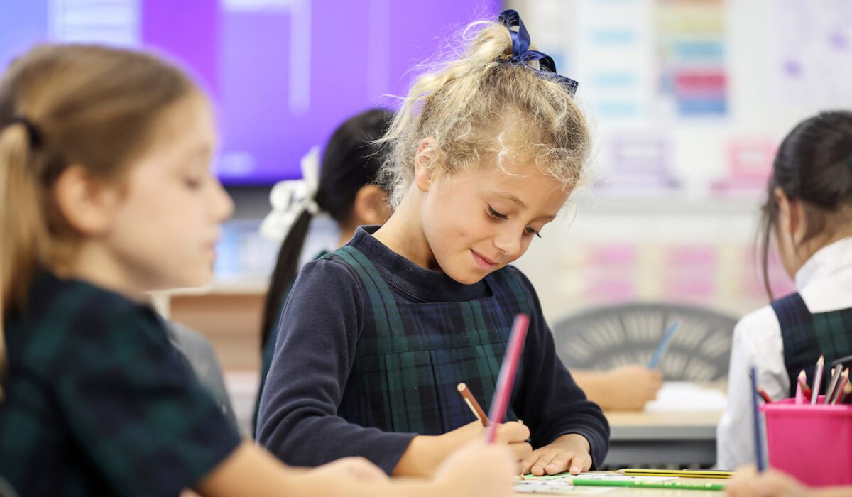 Junior girls writing in class hero